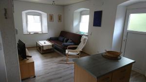 a living room with a couch and a table at Jurahaus Solnhofen in Solnhofen