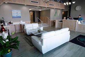 a lobby with white furniture and people at a salon at The Maverick in Ormond Beach +34 photos