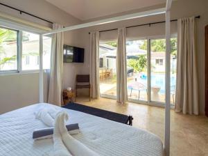una camera con letto e vista sulla piscina di Modern 6 Br Villa With Hot Tub a Sosúa Altre 45 foto