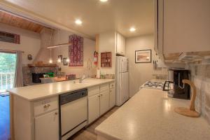 a kitchen with white cabinets and a white refrigerator at Cheyenne's Place home in Kings Beach +12 photos