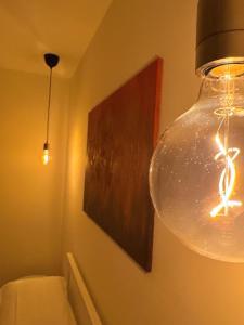 a glass light hanging from a wall in a bathroom at Chez Nunù in Ercolano