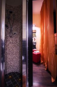 a walk in shower in a bathroom with a shower curtain at La Casetta di Nonna Carmela in Bovino