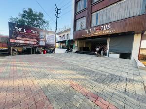 an empty parking lot in front of a building at Hotel The Lotus in Jhānsi