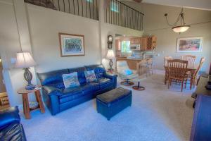 a living room with a blue couch and a kitchen at Park View Paradise condo in Tahoe City