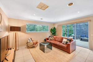 a living room with a couch and a table at Ocean Grove retreat in Ocean Grove