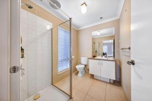 a bathroom with a toilet and a glass shower at Ocean Grove retreat in Ocean Grove +19 photos