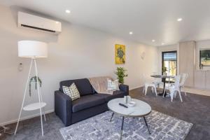 a living room with a couch and a table at Ariki Shire A Wellington Fantasy in Lower Hutt