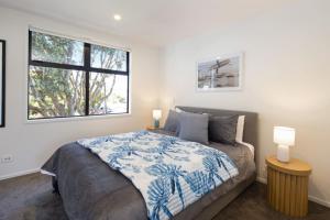 a bedroom with a bed and a window at Ariki Serenade House 2BR Peaceful Stay in Lower Hutt