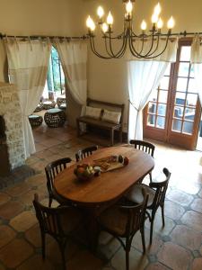 a dining room with a wooden table and chairs at Au bonheur des retrouvailles in Denonville