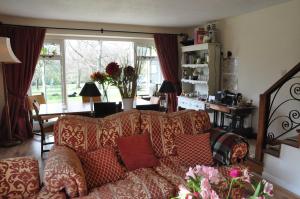 a living room with a couch with pillows on it at Little Tidebrook Farm in Wadhurst