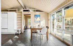 a dining room with a table and chairs at Holiday Home Orionvej Ã Lbãk Ii in Skram