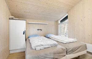 two beds in a room with a window at Holiday Home Orionvej Ã Lbãk Ii in Skram +10 photos