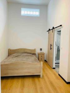 a bedroom with a bed and a door to a closet at Studio calme et lumineux à Uccle in Brussels