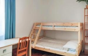 a bunk bed in a room with a desk at 1 Bedroom Nice Apartment In Gdansk in Zaspa