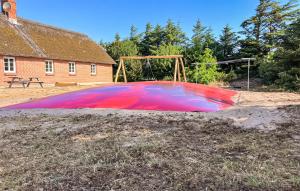 a large red object in front of a playground at Three-Bedroom Holiday Home In Ulfborg in Sundhuse