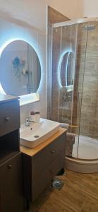 a bathroom with a sink and a shower at Apartment K&M in Senj +8 photos