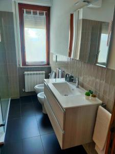 a bathroom with a sink and a toilet and a mirror at Casa a Villa in Perugia +22 photos