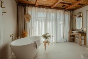 a white bathroom with a tub and a sink at Villa Vena in Zakopane +45 photos