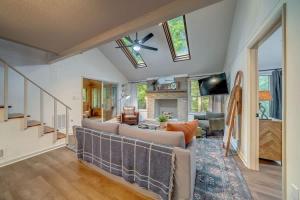 a living room with a couch and a ceiling fan at Secluded Retreat w Hot Tub, FirePit & Pool Access in Hedgesville +48 photos