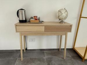 a wooden table with a coffee maker on top of it at The Orange Garden in Corniglia