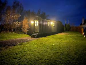 a tiny house in a yard at night at Cater Tober Haven in Wick
