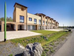 a building with a large rock in front of it at Luxuriöse Ferienwohnung am Störmthaler See in Großpösna