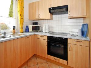 Kuchyň nebo kuchyňský kout v ubytování Bungalow Arielle, Dornumersiel