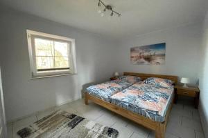 Postel nebo postele na pokoji v ubytování Einladende Ferienwohnung auf Fehmarn