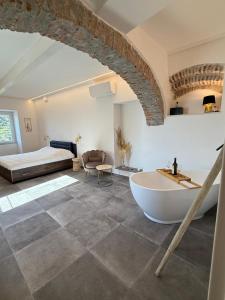 a large bathroom with a tub and a bed at The Orange Garden in Corniglia +107 photos