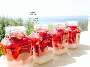 a group of four mason jars filled with strawberries at Stefanos Village Hotel in Plakias