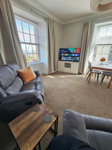 a living room with a couch and a table at Ocean View 2 in Campbeltown