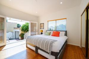 a bedroom with a bed and a large window at Pool Spa Games Peaceful Garden Retreat in Glendale +64 photos