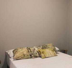 two pillows sitting on top of a bed at Inti Belén in Belén