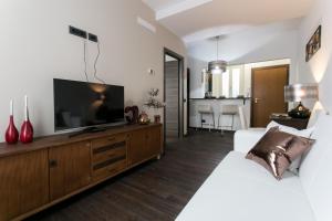 TV a/nebo společenská místnost v ubytování Aparthotel Dei Mercanti