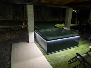 a swimming pool with a bench in a yard at night at Otoka Josikovic in Šipovo