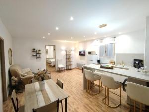 a kitchen and living room with a table and chairs at Charmant Appartement en Provence in Caromb