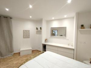a white bathroom with a sink and a mirror at Charmant Appartement en Provence in Caromb