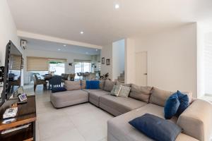 a living room with a couch and a table at Casa Acalan in Puerto Morelos