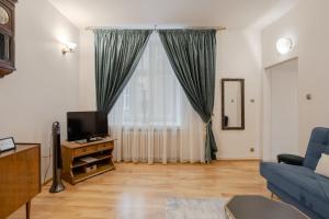 Televízia a/alebo spoločenská miestnosť v ubytovaní Time Apartment