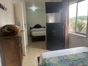 Letto o letti in una camera di Hotel Portal Guatapé