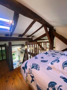 a bedroom with a bed in a room with wooden floors at Le Nid Paisible in Verdun