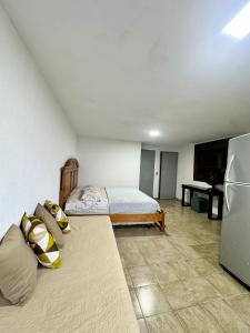a bedroom with a bed and a refrigerator at Apartamento com varanda 201 in Brasilia