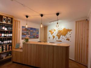 a bar in a wine shop with a map on the wall at 33 Hostel - Youth Hostel 18 to 35 Only in Baleal