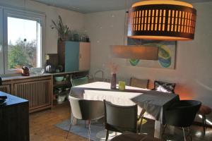 a dining room with a table and some chairs at Fein raus aufs Land in Gummersbach