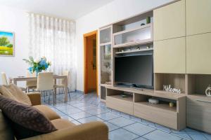a living room with a large entertainment center with a television at I Tre Delfini apartment in center-Sorrento Coast in Vico Equense