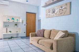 a living room with a couch and a door at I Tre Delfini apartment in center-Sorrento Coast in Vico Equense +18 photos