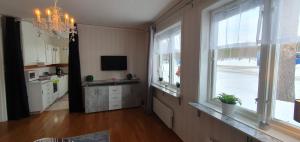 a large living room with windows and a television at Ferienstuga Lappland Kristineberg in Kristineberg