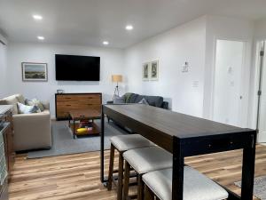 a living room with a large black table and chairs at The 605 House in De Smet