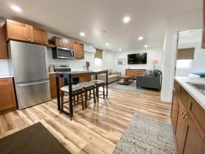 a kitchen and living room with a table and a refrigerator at The 605 House in De Smet