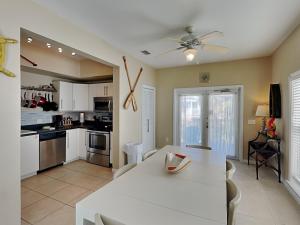 a kitchen and dining room with a white table at La Favorita in Navarre +17 photos